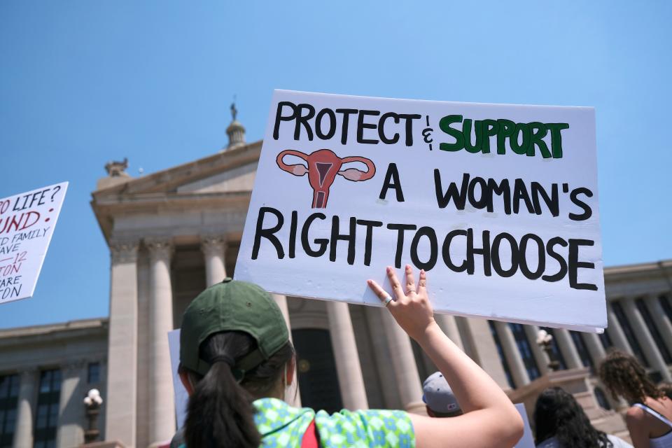 A rally participant's sign proclaims her support of women's productive rights during pro-choice rallies at the Capitol, Saturday, May 14, 2022