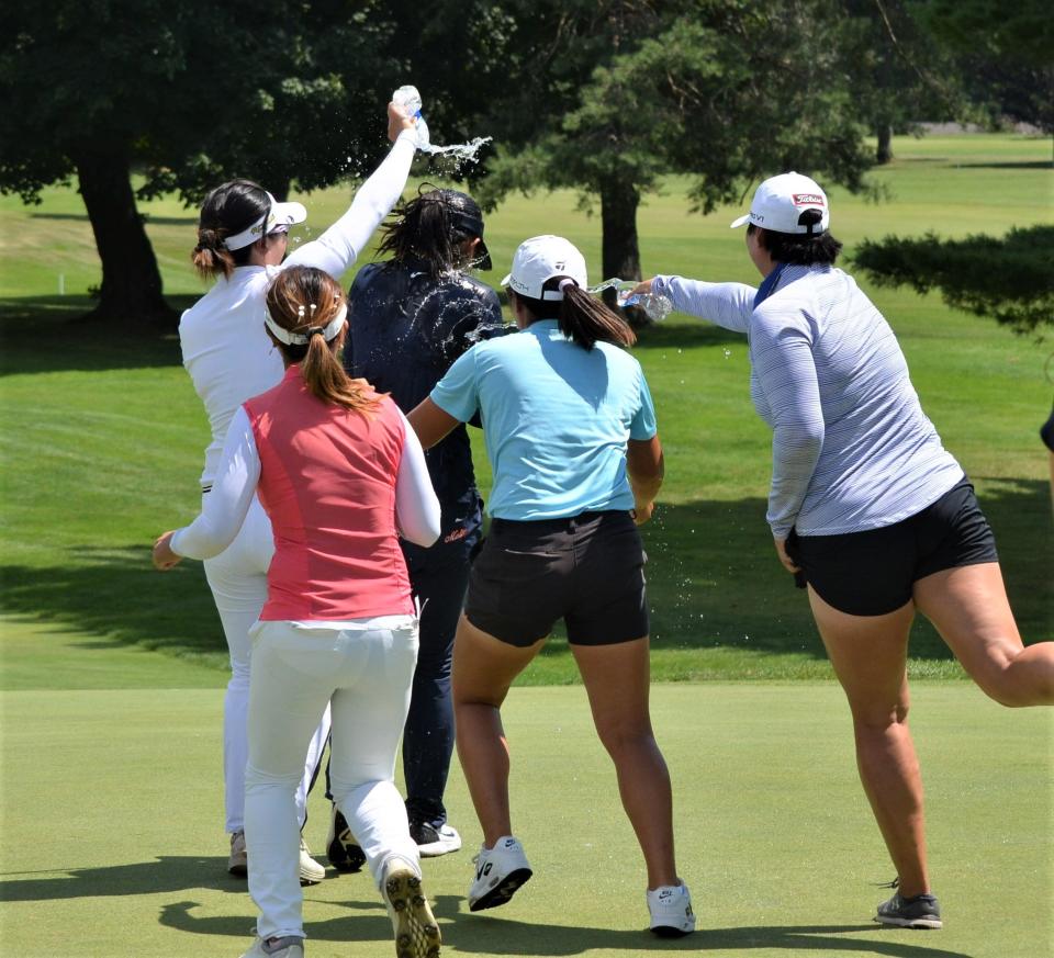 Players congratulate Xiaowen Yin on her first career win on the Epson Tour by dumping water bottles on her head, something that has become a tradition at the FIreKeepers Casino Hotel Championship in Battle Creek.