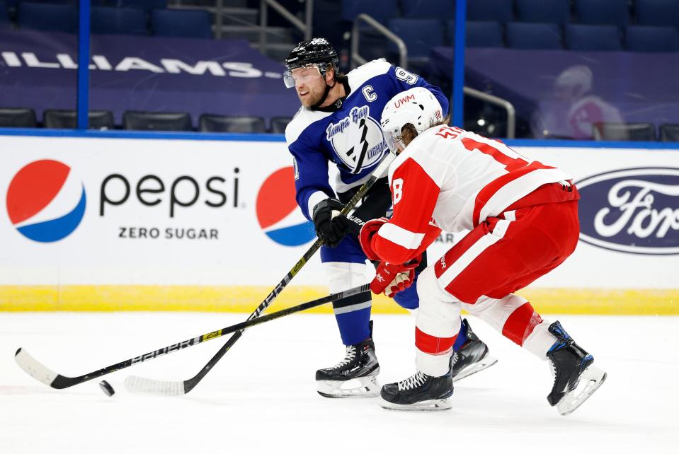 Tampa Bay Lightning center Steven Stamkos (91) shoots as Detroit Red Wings defenseman Marc Staal (18) defends during the first period Feb. 5, 2021, at Amalie Arena.