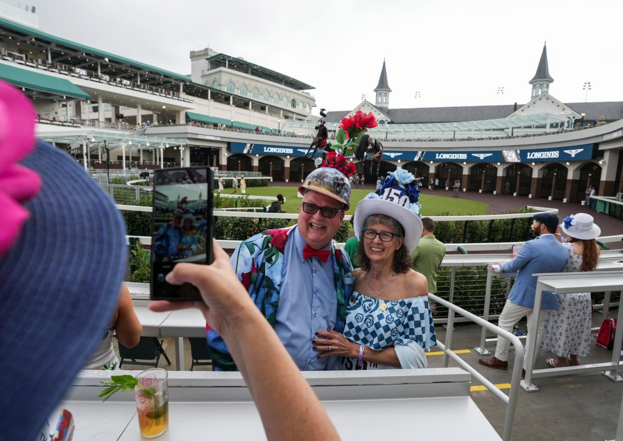 A Derby veteran since 1977, Skip Keopnick and wife Mary -- with a nod to the 150th Run For the Roses on her hat -- get their photo snapped by a guest inside the Churchill Downs' Paddock on Kentucky Derby day Saturday, May 4, 2024 in Louisville, Kentucky. On a card he gives out, he's quoted as "There are no bad Derbys. Some are just better than others." Skip made his hat which has a revolving Derby horse.