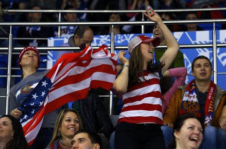 Team USA fans celebrate during the USA versus Slovakia men's preliminary round ice hockey game at the 2014 Sochi Winter Olympics, February 13, 2014. REUTERS/Brian Snyder