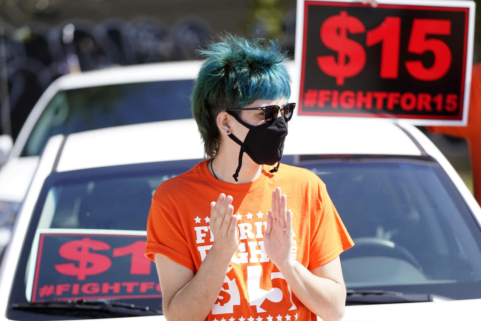 Cristian Cardona, an employee at a McDonald's, attends a rally for a $15 an hour minimum wage Tuesday, Feb. 16, 2021, in Orlando, Fla. (AP Photo/John Raoux)