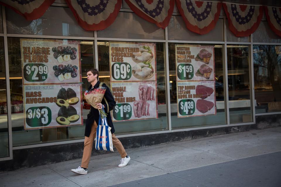 A man walks past advertisements on windows of a grocery store in the Brooklyn borough of New York, the United States, on Feb. 14, 2023. The U.S. Labor Department reported Tuesday that U.S. consumer price index, a major gauge of inflation, rose 0.5 percent in January on a monthly basis, the biggest increase in three months and higher than the 0.4 percent expected by economists. The annual rate hit 6.4 percent in January, down slightly from 6.5 percent in December and higher than the market consensus of 6.2 percent. (Photo by Michael Nagle/Xinhua via Getty Images)