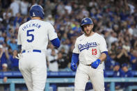 Los Angeles Dodgers' Max Muncy celebrates his grand slam against the Miami Marlins with Freddie Freeman (5) during the first inning of a baseball game Tuesday, May 7, 2024, in Los Angeles. (AP Photo/Marcio Jose Sanchez)
