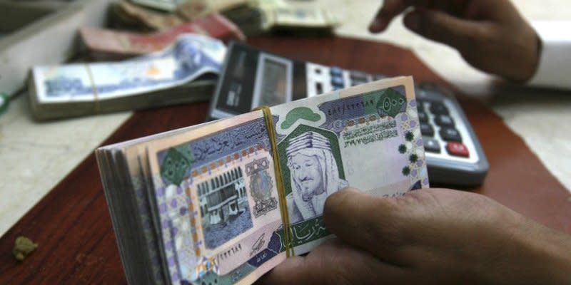 A Saudi money exchanger counts Saudi riyals in Riyadh August 4, 2008. REUTERS/Fahad Shadeed