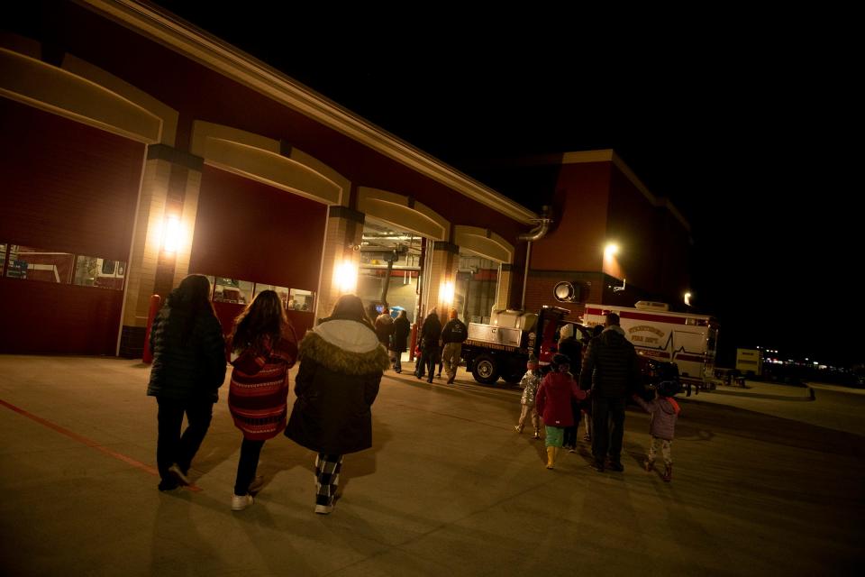 The crowd walks to the Streetsboro Fire Station Thursday night for cookies and hot chocolate after the annual Holiday Lighting Ceremony.