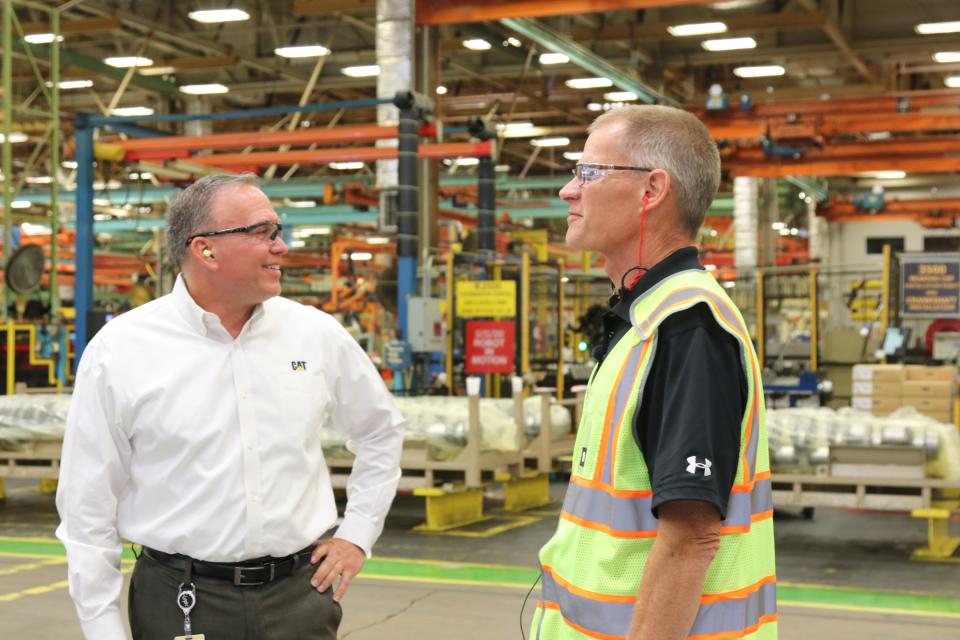 Joe Markun, the general manager of the Lafayette location, and Greg Folkerts, a Caterpillar tour guide, talk about the productive day that the facility had on June 28, 2022, in Lafayette.