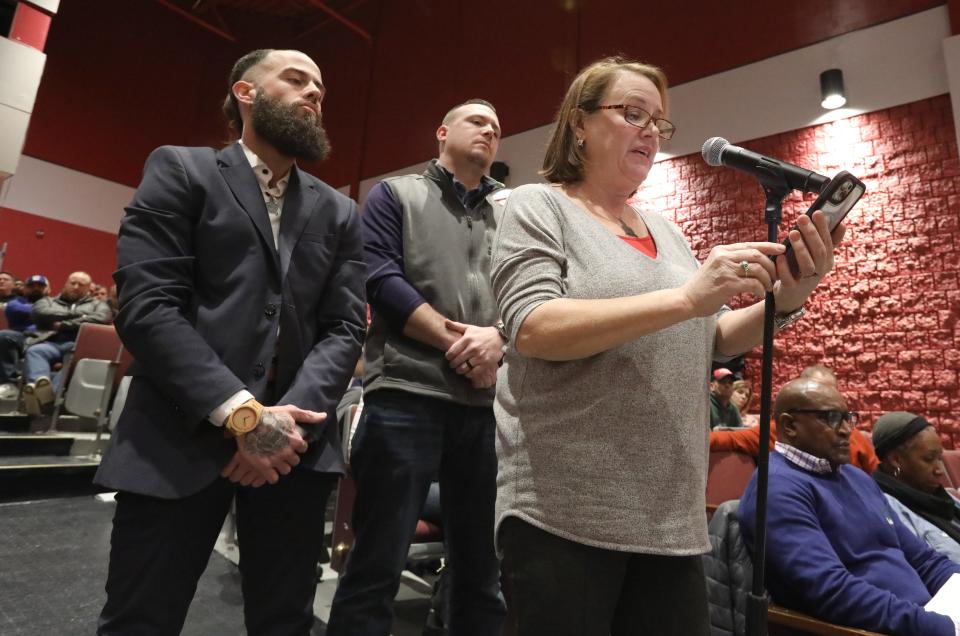 Margaret Siegriest, with her sons, Sean and Brendan, speaks before the Nyack School Board during a public meeting at Nyack High School Jan. 23, 2024. A resolution was approved to remove the name of former head coach Dave Siegriest's from the baseball field and other sites.