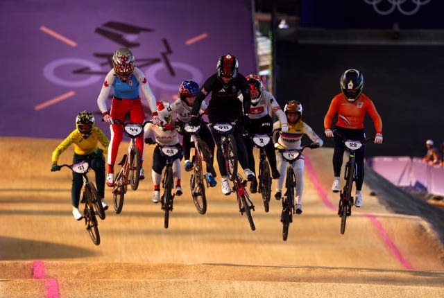 The BMX riders in action, jumping. 