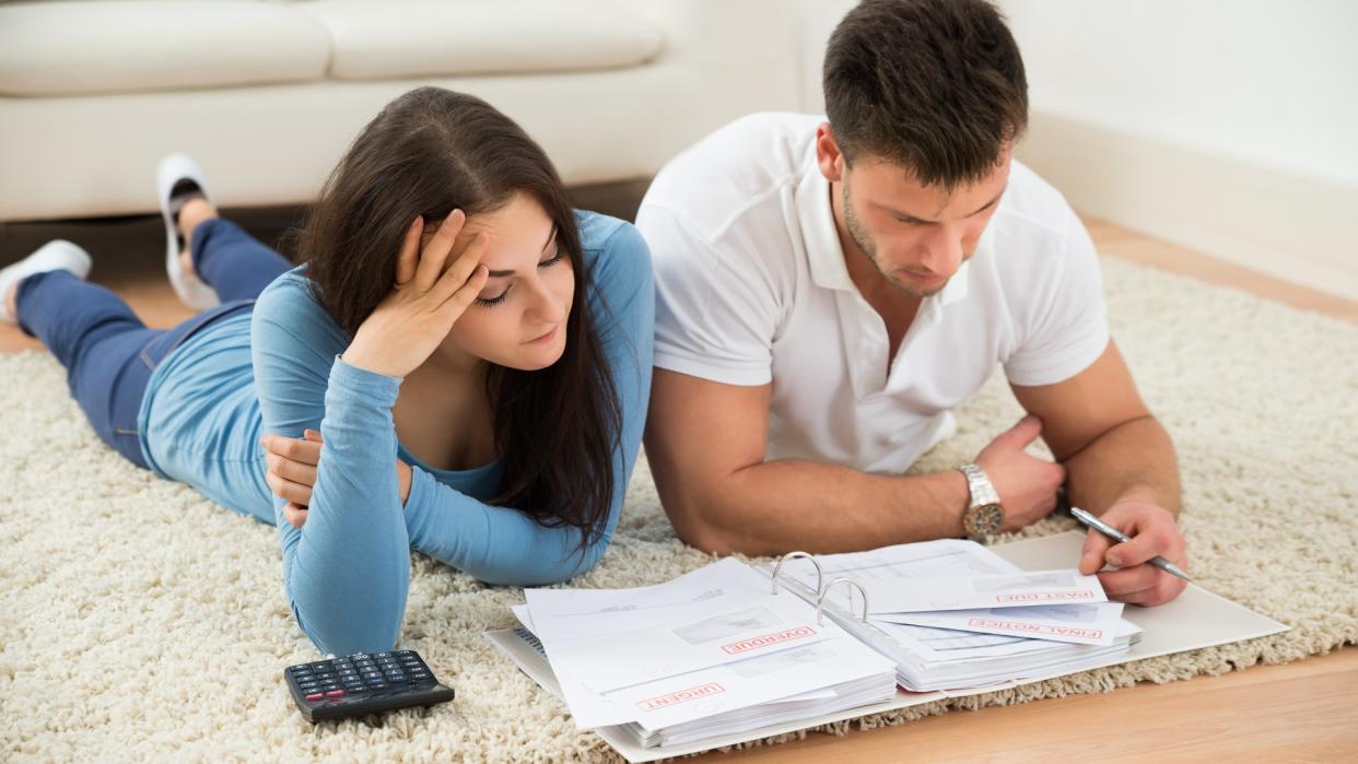 couple on the floor filling out paper work