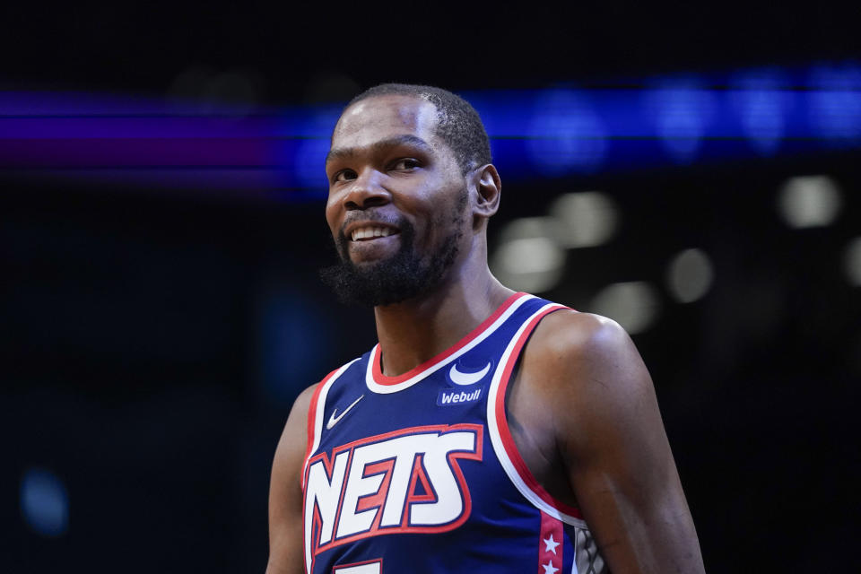 FILE -Brooklyn Nets' Kevin Durant smiles during the first half of an NBA basketball game against the Indiana Pacers at the Barclays Center, Sunday, Apr. 10, 2022, in New York. Kevin Durant and the Brooklyn Nets plan to stay together after all, even after the All-Star forward asked to be traded earlier this summer. The Nets said Tuesday, Aug. 23, 2022, that the team's leadership met a day earlier with Durant and business partner Rich Kleiman in Los Angeles and “agreed to move forward with our partnership,” general manager Sean Marks said in a statement.(AP Photo/Seth Wenig, File)