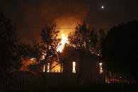 <p>A house burns in the town of Mati, east of Athens, Monday, July 23, 2018. Regional authorities have declared a state of emergency in the eastern and western parts of the greater Athens area as fires fanned by gale-force winds raged through pine forests and seaside settlements on either side of the Greek capital. (AP Photo/Thanassis Stavrakis) </p>