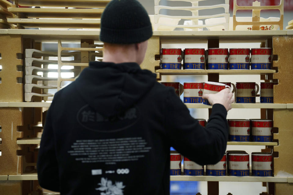 Kiln placer Nathan Davies prepares mugs for firing, at the Duchess China 1888 factory, in Stoke-on-Trent, England, Thursday, March 30, 2023. With just five weeks to go until King Charles III’s coronation, an historic pottery is busy producing “God Save The King” commemorative china plates and mugs to mark the occasion. (AP Photo/Jon Super)