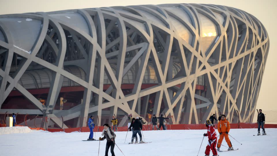 People ski on a slope in front of China's National Stadium, also known as the Bird's Nest, in Beijing on January 7, 2010. The structure was designed by Arup for the 2008 Summer Olympics and Paralympics. - Liu Jin/AFP/Getty Images/File