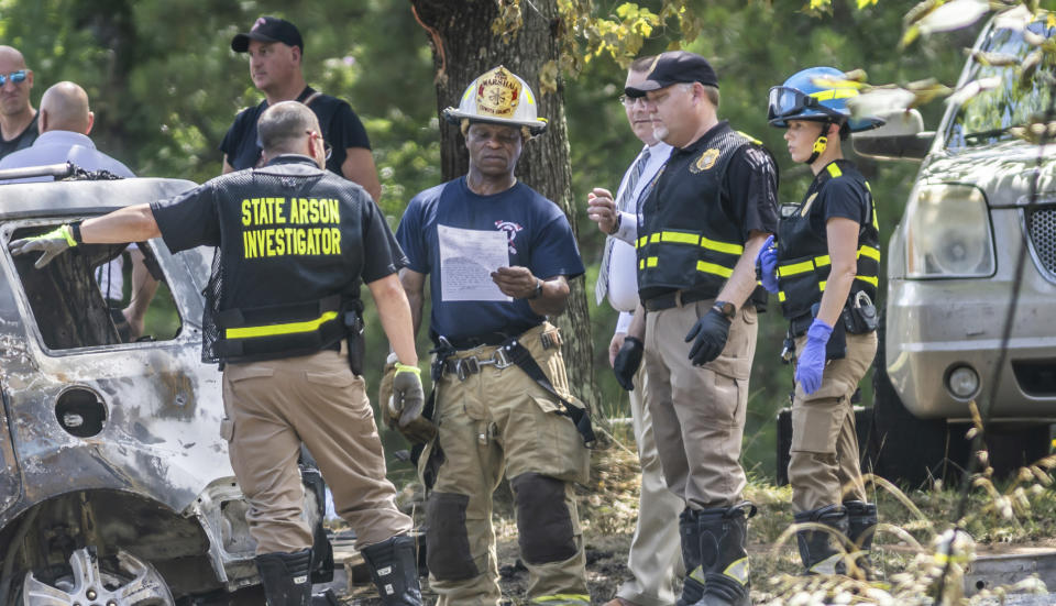 Fire and law enforcement investigators work on the scene of a house fire in Newnan, Ga. on Monday, June 17, 2024. (John Spink/Atlanta Journal-Constitution via AP)