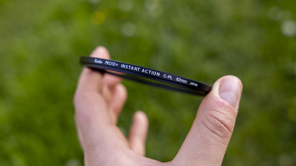 The Kenko Pro1D+ circular polarizing filter held in a woman's hands