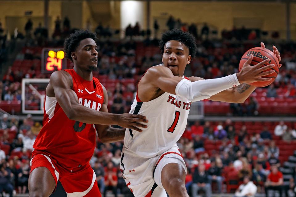 Texas Tech's Terrence Shannon, Jr. (1) drives the ball around Lamar's Lincoln Smith (0) during the first half of an NCAA college basketball game on Saturday, Nov. 27, 2021, in Lubbock, Texas.