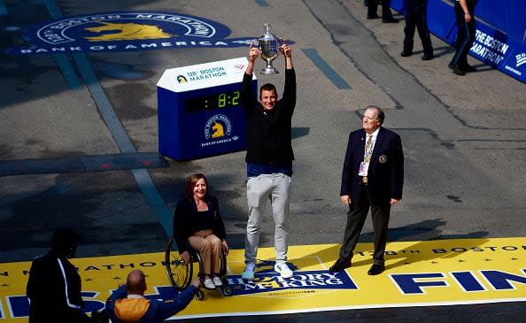 BOSTON, MASSACHUSETTS - APRIL 15: Boston Marathon Grand Marshal and former New England Patriot Rob Gronkowski shows off the winner's trophy at the finish line during the 128th Boston Marathon on April 15, 2024 in Boston, Massachusetts. (Photo by Omar Rawlings/Getty Images)