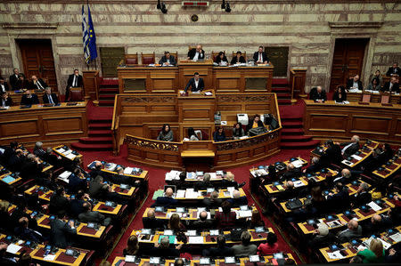 Greek Prime Minister Alexis Tsipras addresses lawmakers as Parliament Speaker Nikos Voutsis (top C) chairs a parliamentary session before a vote on setting up a special committee which will probe the role of ten politicians in a case which involves alleged bribery by Swiss drugmaker Novartis, in Athens, Greece, February 22, 2018. REUTERS/Alkis Konstantinidis