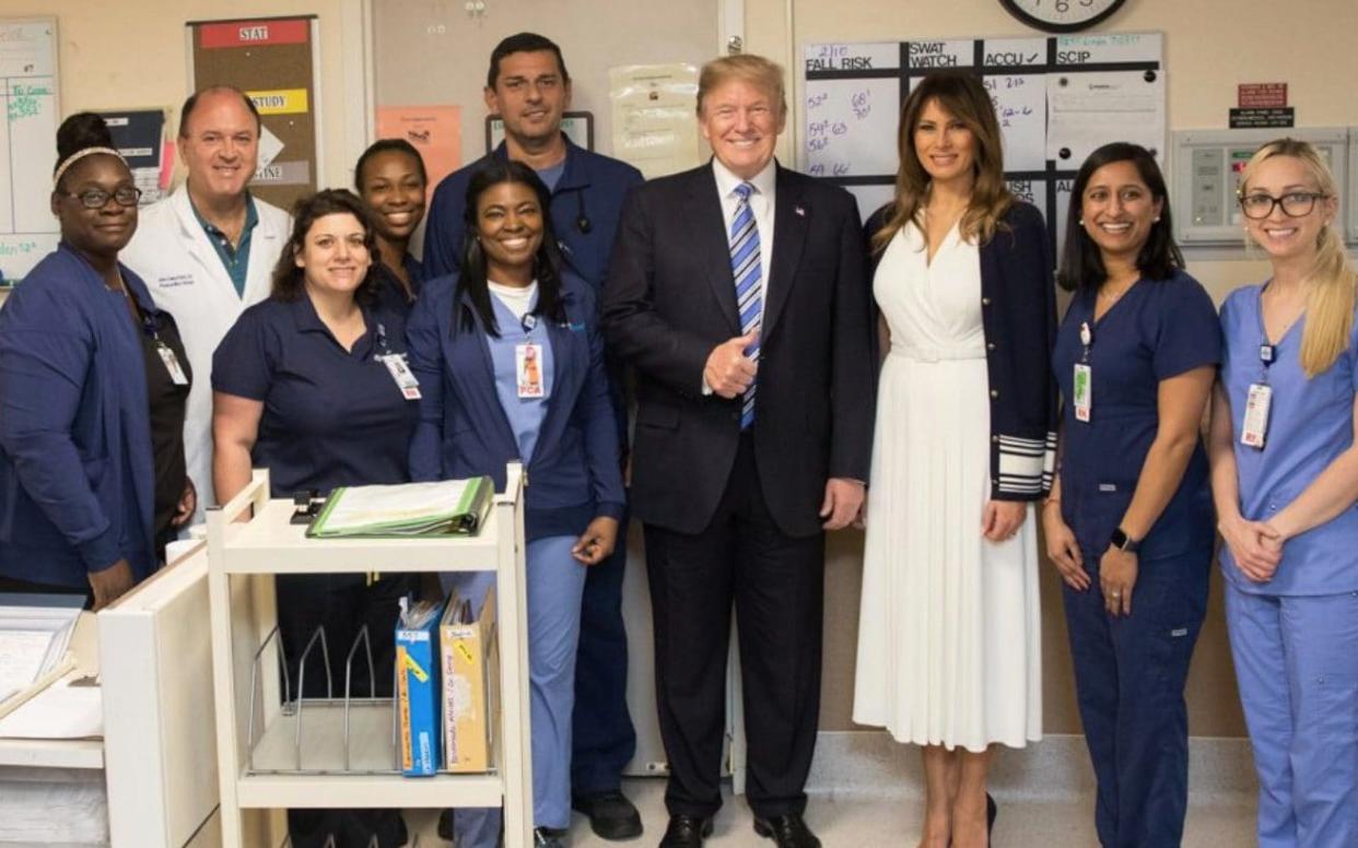 Donald Trump gives a thumbs up as he poses for a photo with Broward Health North Hospital staff, two days after 17 people were killed at a Florida school - Twitter/DonaldTrump