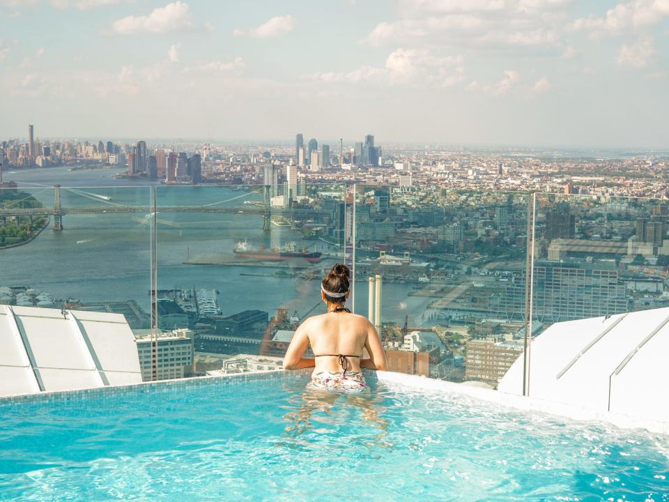 The author swims with the NYC skyline in the background.