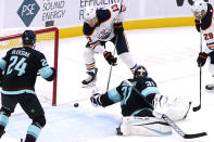 Seattle Kraken goaltender Philipp Grubauer (31) reaches across to make a save on a shot from Edmonton Oilers right wing Jesse Puljujarvi (13) during the third period of an NHL hockey game Friday, Dec. 3, 2021, in Seattle. (AP Photo/Elaine Thompson)