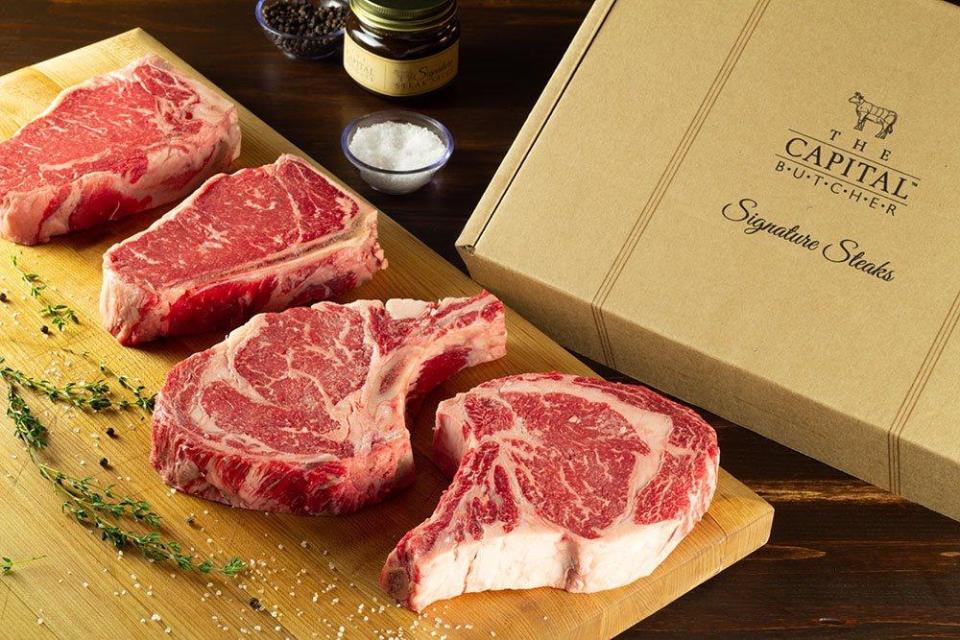 The Capital Grille's "Steak Grille Boxes" offer a foursome of steaks ready for the grill. Shown here: two New York strip steaks and two rib eye steaks.