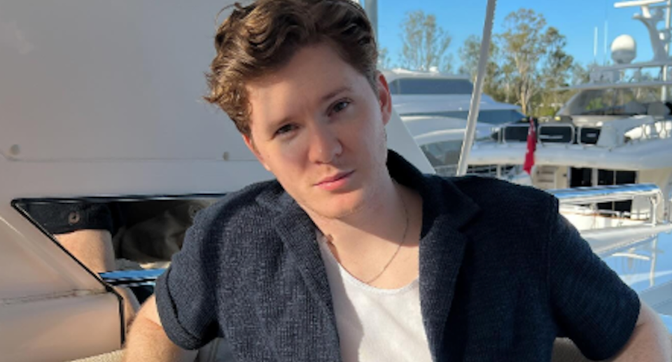 Young businessman Taylor Reilly sitting on a boat.