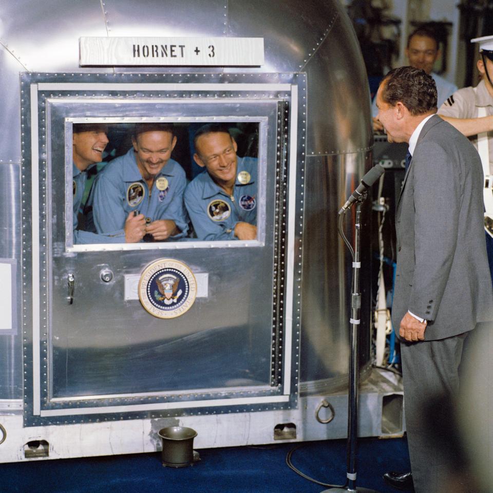 President Richard M. Nixon was in the central Pacific recovery area to welcome the Apollo 11 astronauts aboard the U.S.S. Hornet, prime recovery ship for the historic Apollo 11 lunar landing mission. Already confined to the Mobile Quarantine Facility (MQF) are (left to right) Neil A. Armstrong, commander; Michael Collins, command module pilot; and Edwin E. Aldrin Jr., lunar module pilot. Apollo 11 splashed down at 11:49 a.m. (CDT), July 24, 1969, about 812 nautical miles southwest of Hawaii and only 12 nautical miles from the U.S.S. Hornet. (Photo: NASA)