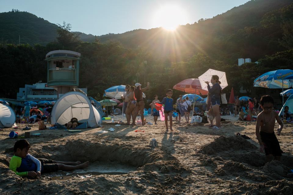 This photo taken on July 24, 2022 shows beachgoers at Clear Water Bay during a heat wave in Hong Kong. (Photo by Yan Zhao / AFP) (Photo by YAN ZHAO/AFP via Getty Images)