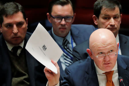 Russian Ambassador to the United Nations (U.N.) Vasily Nebenzya holds a copy of a British report on an incident in Salisbury, UK, during a meeting of the U.N. Security Council at U.N. headquarters in New York, U.S., April 5, 2018. REUTERS/Lucas Jackson