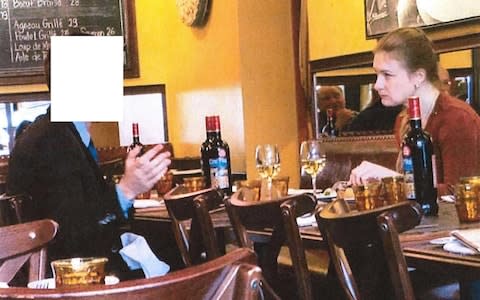 Accused Russian agent Maria Butina shown sitting at a table with a suspected Russian Intel Operative in a restaurant - Credit: Reuters