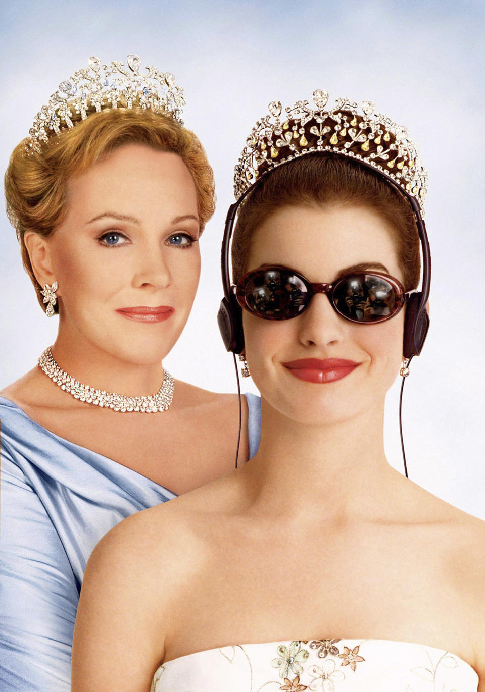 Julie Andrews and Anne Hathaway from "The Princess Diaries" wearing tiaras, Anne with headphones