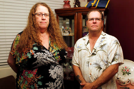 Jim Stauffer and his wife Lisa Stauffer pose for a photo in their home in Surprise, Arizona, U.S. December 21, 2016. REUTERS/Ricardo Arduengo