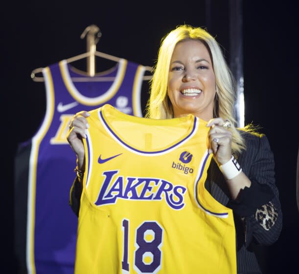 EL SEGUNDO, CA - September 20: Jeanie Buss, CEO / Governor / Co-owner of the Los Angeles Lakers, holds a new Lakers jersey as the Lakers host a 2021-2022 season kick-off event to unveil and announce a new global marketing partnership with Bibigo, which will appear on the Lakers' jersey at the UCLA Health Training Center in El Segundo on Monday, Sept. 20, 2021. (Allen J. Schaben / Los Angeles Times)