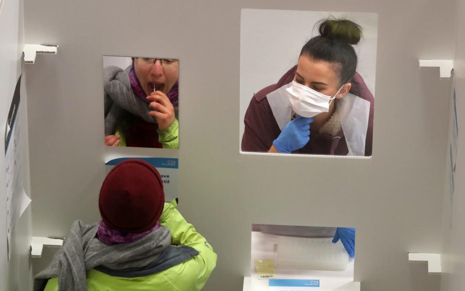 A student has an asymptomatic test using lateral flow antigen at a test centre at Edinburgh University ahead of being allowed to travel home for the Christmas holidays - Andrew Milligan/PA Wire