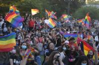 Members of the Movement for Homosexual Integration and Liberation celebrate after lawmakers approved legislation legalizing marriage and adoption by same-sex couples, in Santiago, Chile, Tuesday, Dec. 7, 2021. (AP Photo/Esteban Felix)