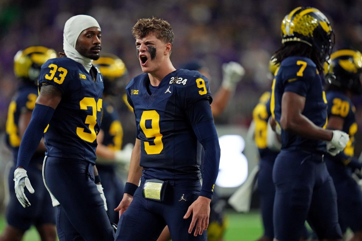 Michigan Wolverines quarterback J.J. McCarthy (9) celebrates from the sidelines during the fourth quarter against the Washington Huskies in the 2024 College Football Playoff national championship game at NRG Stadium.
