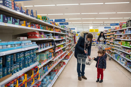 Maria, 31, and her daughter Elena, who is two years and seven-months old, buy some caviar, Elena's favourite food, while out shopping in London, Britain, February 22, 2019. REUTERS/Alecsandra Dragoi