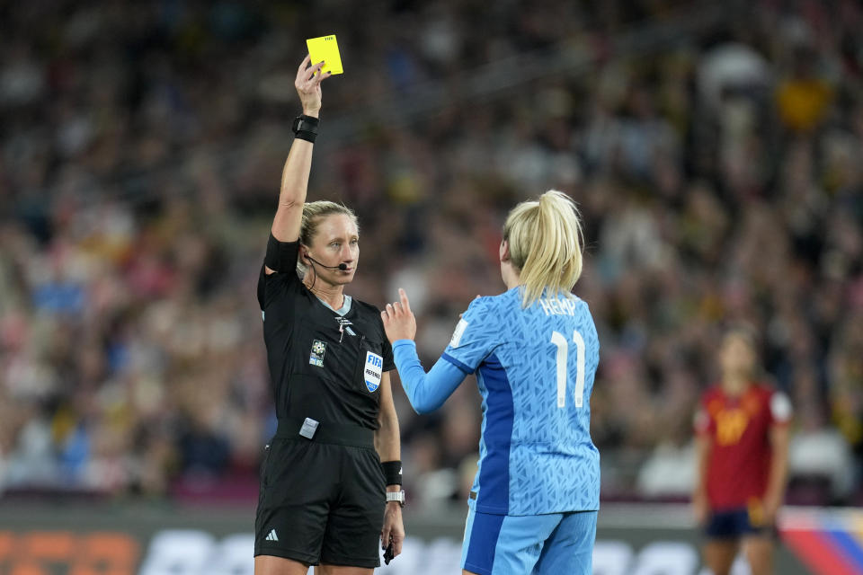 Referee Tori Penso shows a yellow card to England's Lauren Hemp during the Women's World Cup soccer final between Spain and England at Stadium Australia in Sydney, Australia, Sunday, Aug. 20, 2023. (AP Photo/Abbie Parr)