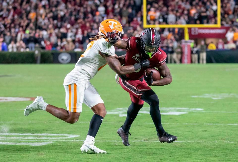 South Carolina Gamecocks tight end Jaheim Bell (0) fends off the tackle of Tennessee Volunteers defensive back Tamarion McDonald (12) at Williams-Brice Stadium in Columbia, SC on Saturday, Nov. 19, 2022.