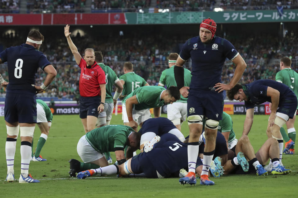 Scotland's players, in dark blue, react as Ireland scored a try during the Rugby World Cup Pool A game at International Stadium between Ireland and Scotland in Yokohama, Japan, Sunday, Sept. 22, 2019. (AP Photo/Eugene Hoshiko)