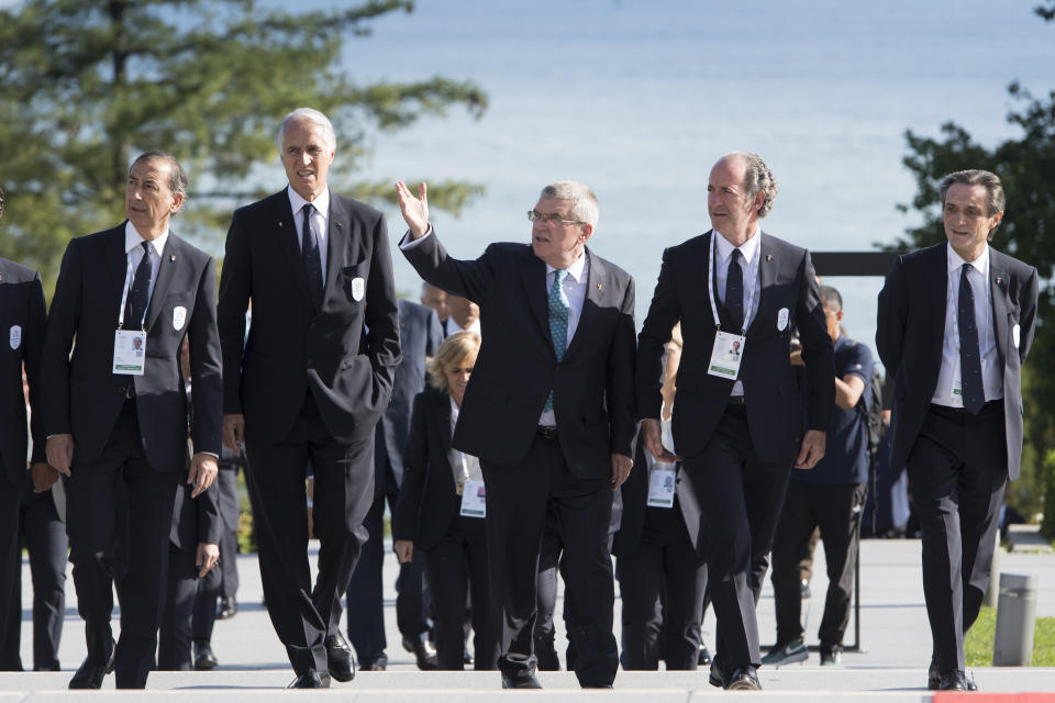 International Olympic Committee (IOC) president Thomas Bach, center, Italy's Under Secretary of State Giancarlo Giorgetti, left, Italian National Olympic Committee (CONI) president Giovanni Malago, second left, the mayor of Milan Giuseppe Sala, second right, and Italy's Lombardy region President Attilio Fontana, right, before a meeting at the Olympic Museum, in Lausanne, Switzerland, Sunday, June 23, 2019. The host city of the 2026 Olympic Winter Games will be decided in Lausanne on Monday. (Laurent Gillieron/Keystone via AP)