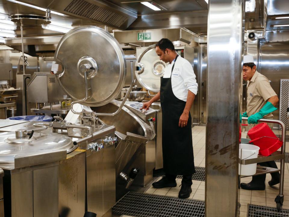 people and large soup pots in a kitchen on Royal Caribbean's Icon of the Seas