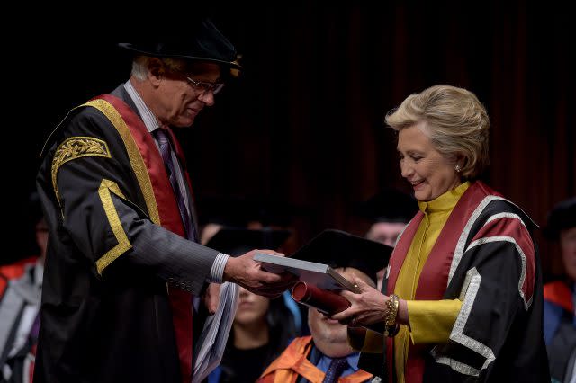 Mrs Clinton was handed a book of her Welsh family history by Pro-Chancellor Sir Roderick Evans (Ben Birchall/PA)