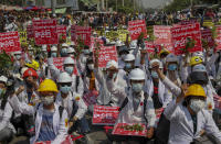 Medical students display placards during an anti-coup demonstration in Mandalay, Myanmar, Thursday, March 4, 2021. Demonstrators in Myanmar protesting last month's military coup returned to the streets Thursday, undaunted by the killing of at least 38 people the previous day by security forces. Placards read as "Let's start the public administrative platform accordingly."(AP Photo)