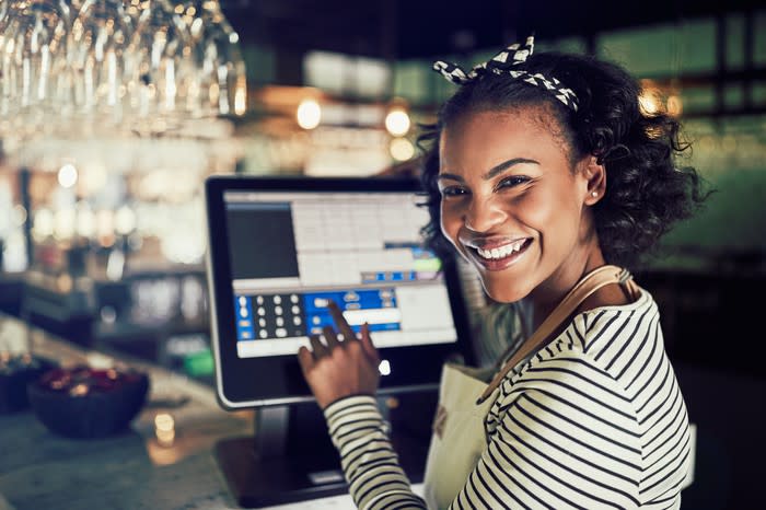 A young sales associate using a point-of-sale system.