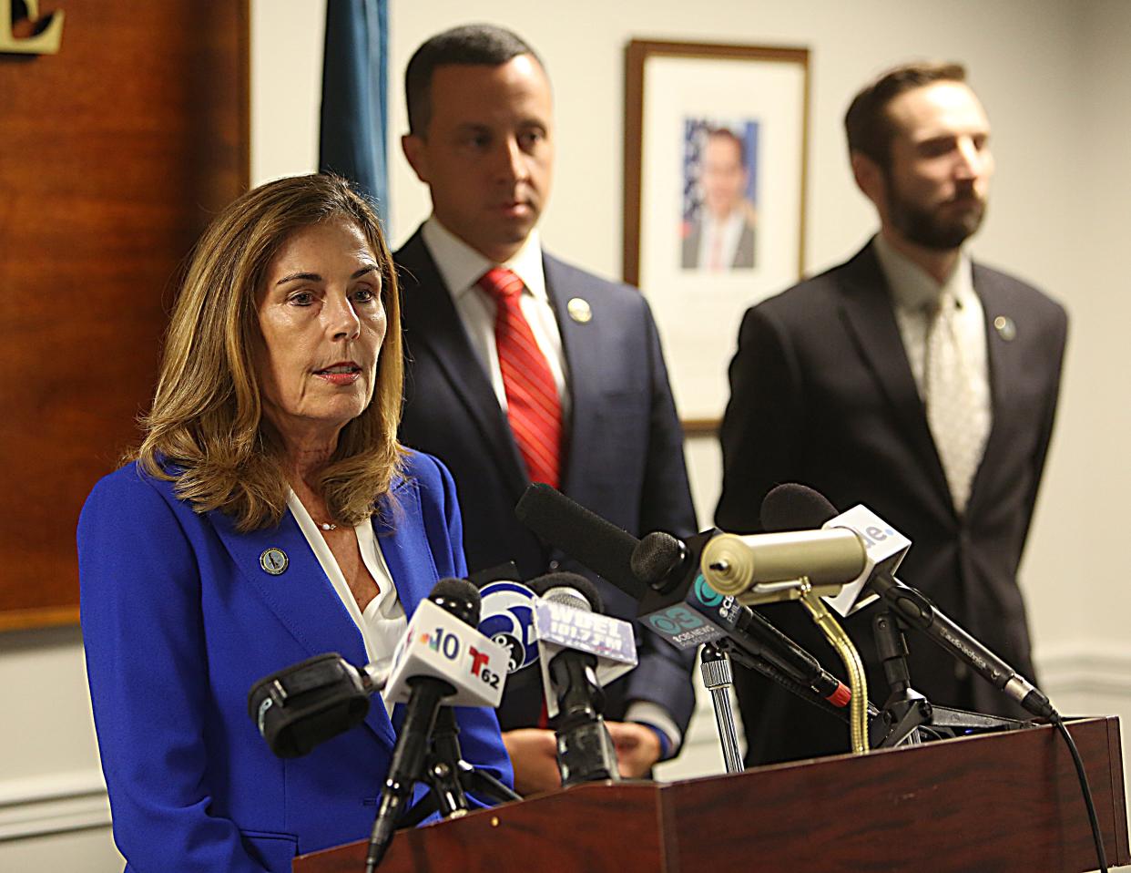 Delaware Attorney General Kathleen Jennings (left) speaks at a press conference on Tuesday afternnon announcing charges filed against a Delaware State Police trooper.