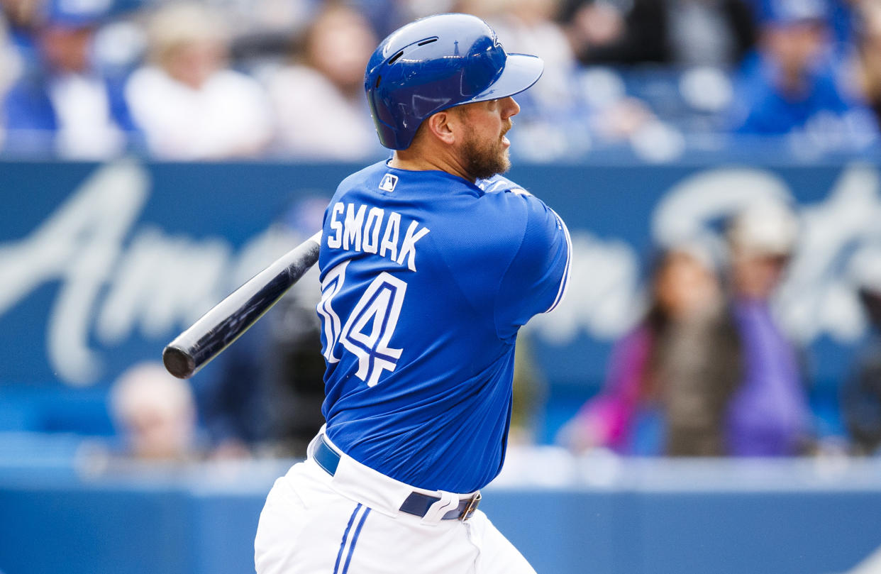 TORONTO, ONTARIO - SEPTEMBER 29: Justin Smoak #14 of the Toronto Blue Jays hits a two-run double against the Tampa Bay Rays in the first inning  at the Rogers Centre on September 29, 2019 in Toronto, Canada. (Photo by Mark Blinch/Getty Images)