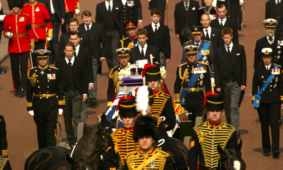 403363 01: Prince Charles (C) with other members of the British Royal Family walk behind a coffin bearing the Queen Mother April 5, 2002 as her ceremonial procession makes its way down The Mall in London. The Queen Mother's body will lie in state in Westminster Hall before her funeral in four days. (Photo by Sion Touhig/Getty Images)